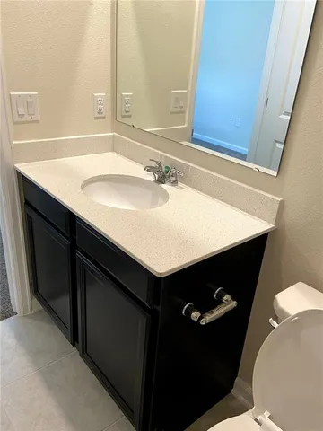 a bathroom with a sink vanity and a mirror