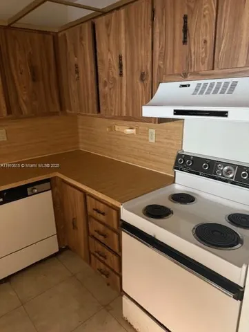 a kitchen with granite countertop a sink and a stove