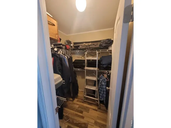a bathroom with a granite countertop sink a mirror and a shower