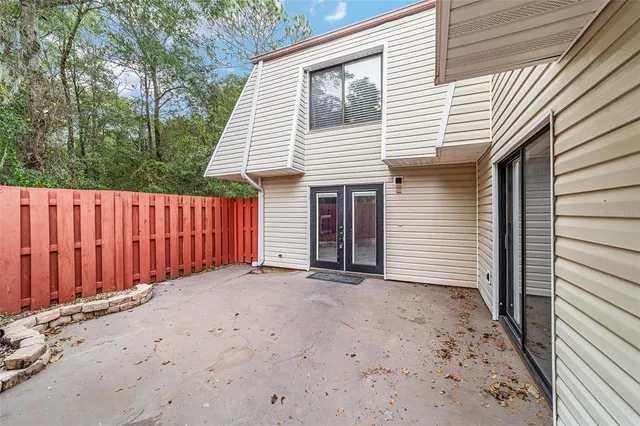 a view of a house with a wooden fence