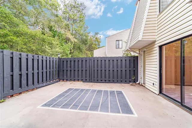 a view of deck with wooden fence and trees