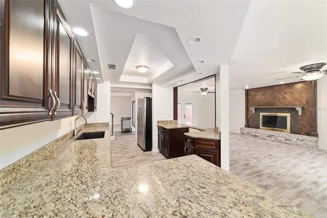 a view of a hallway with furniture and a fireplace