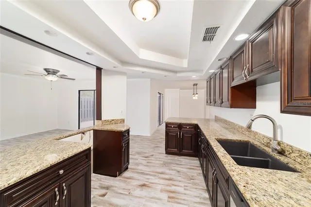 a kitchen with stainless steel appliances granite countertop a sink stove and refrigerator