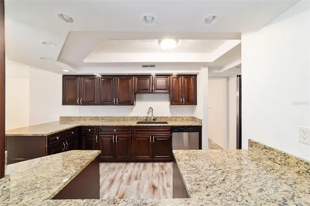 a kitchen with a sink and wooden cabinets