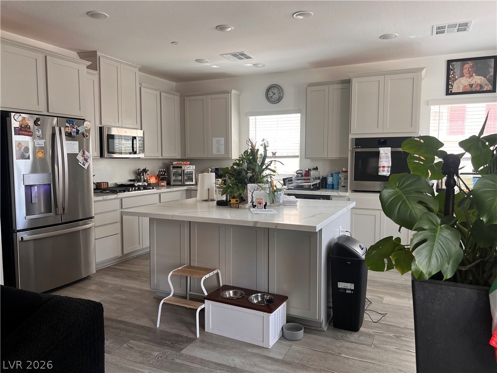 2555 Hampton Road, Unit 2207 Henderson, NV 89052 - Photo 23 of 34 Culinary dreams come alive in this kitchen, featuring an expansive island and sleek stainless steel appliances.