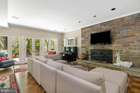 a living room with fireplace furniture and a flat screen tv