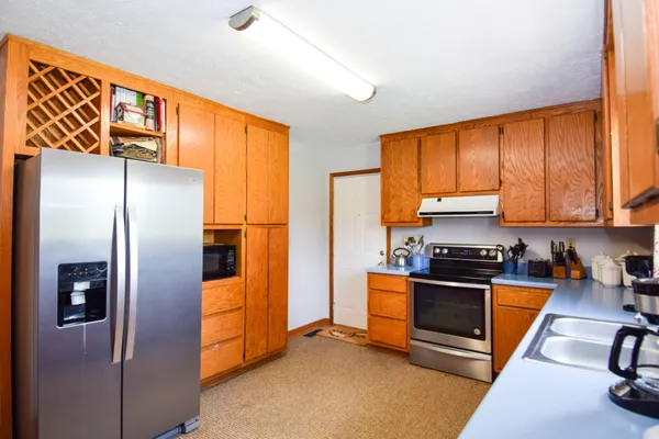 a kitchen with stainless steel appliances granite countertop a refrigerator stove and oven