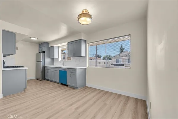 a kitchen with a refrigerator and a sink