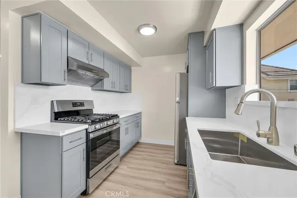a kitchen that has a sink and a stove