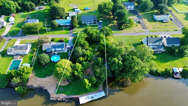 an aerial view of a house with a garden and lake view