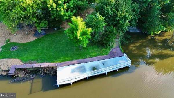 a backyard of a house with a yard and outdoor seating