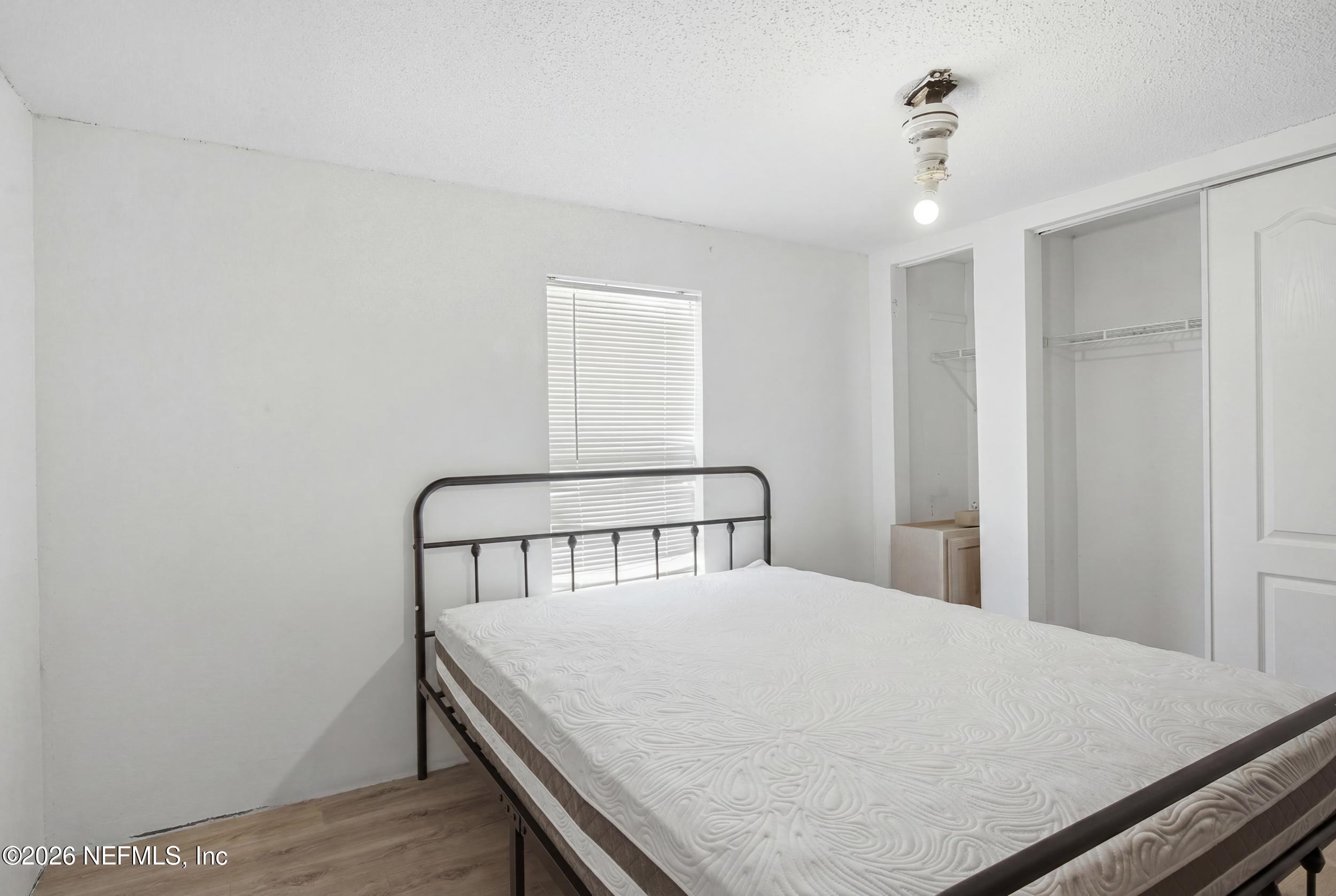 5667 Long Branch Cemetery Road Jacksonville, FL 32234 - Photo 15 of 24 a bedroom with a bed and a table