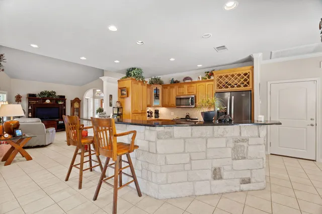 a view of a kitchen with kitchen island dining table and chairs