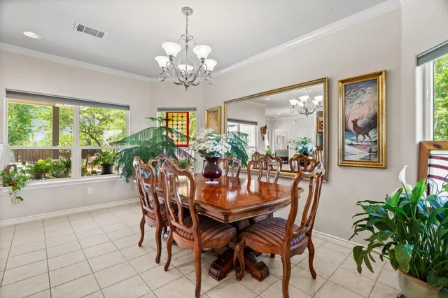a view of a dining room with furniture a chandelier and wooden floor