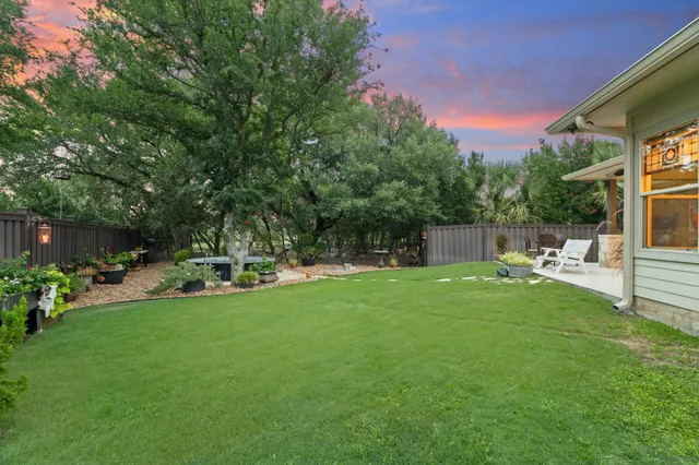 a view of a backyard with sitting area