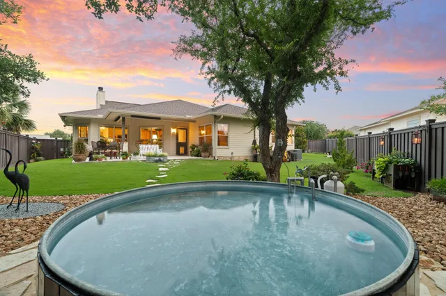 a swimming pool with outdoor seating and yard