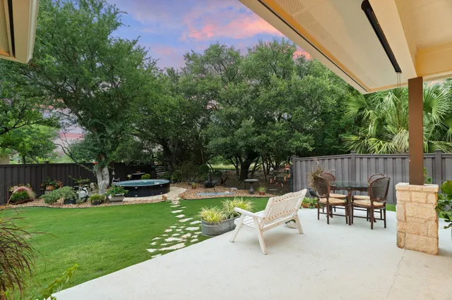 a view of a patio with couches chairs and a yard