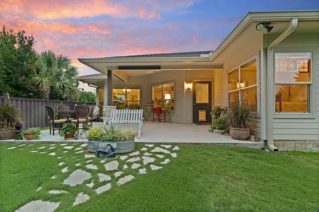 a view of house with backyard and a slide