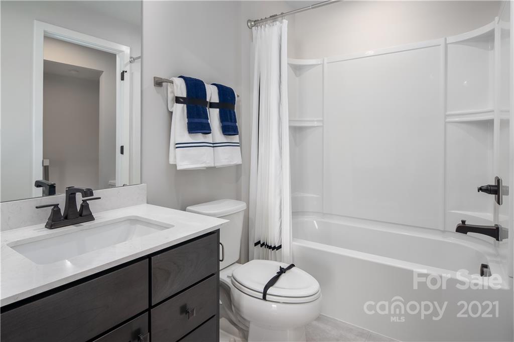2005 Dornoch Road, Unit 1033A Tega Cay, SC 29708 - Photo 2 of 12 a bathroom with a sink and a mirror