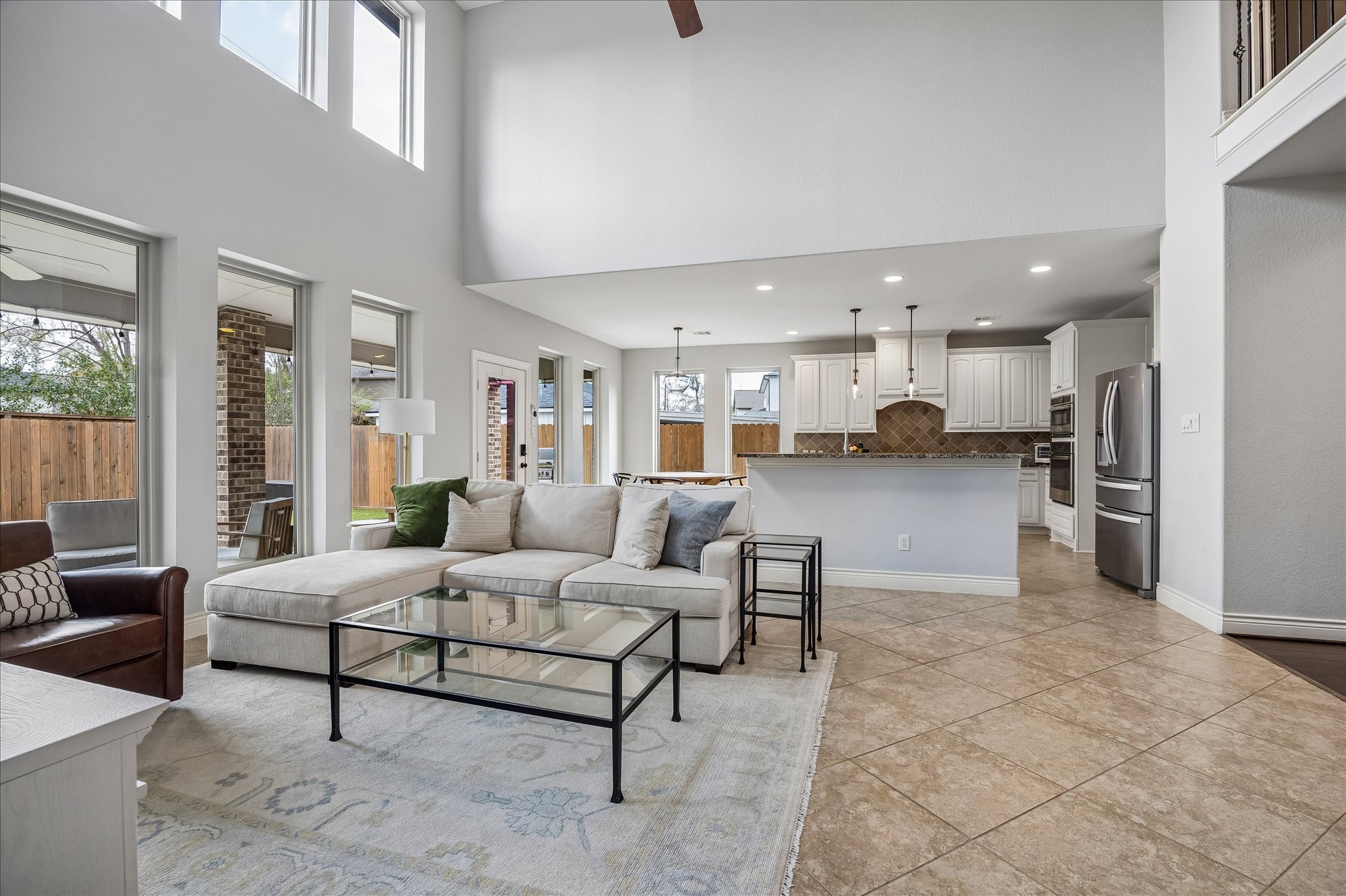 1616 Hewitt Drive Houston, TX 77018 - Photo 8 of 44 Expansive living area flows effortlessly into the kitchen and dining spaces, with high ceilings and large windows bringing in natural light throughout the heart of the home.