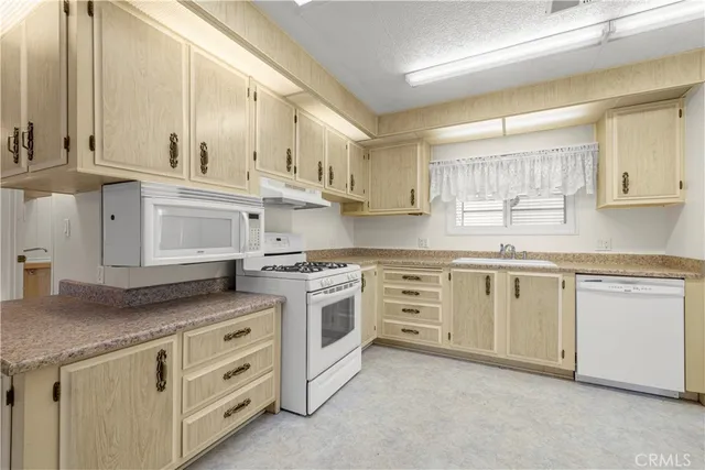 a kitchen with white cabinets