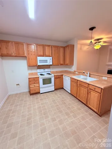 a kitchen with stainless steel appliances granite countertop a sink and cabinets