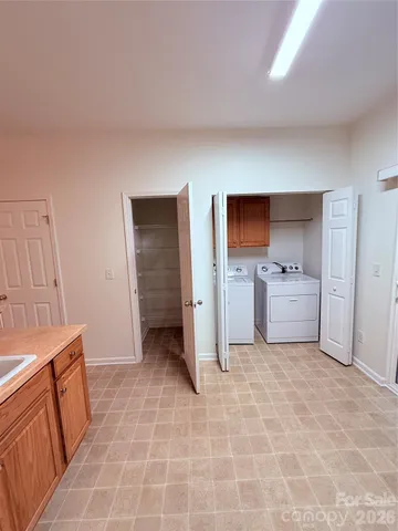 a view of a kitchen with a sink dishwasher and fireplace