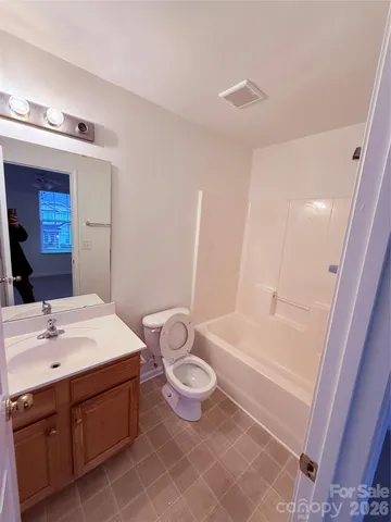 a bathroom with a sink a toilet a mirror and shower