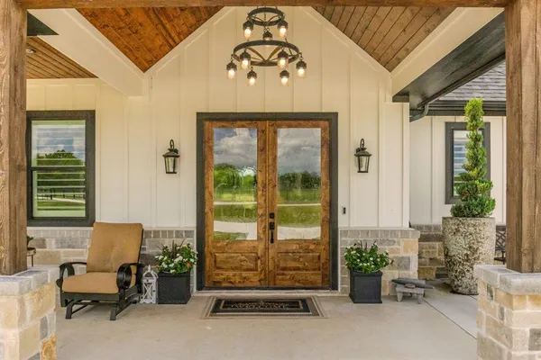 a front view of a house with outdoor seating