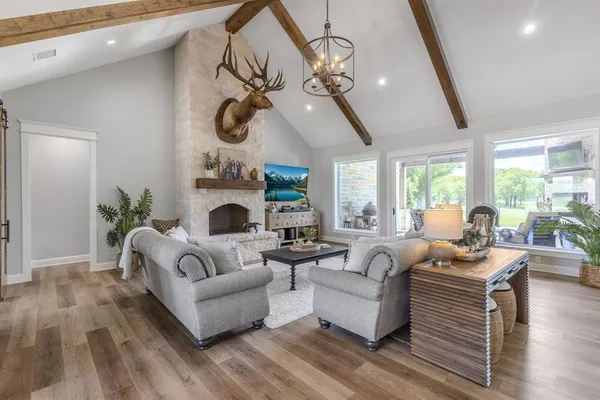a living room with fireplace furniture and a large window