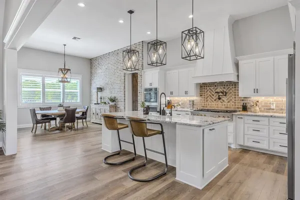a kitchen with center island cabinets and stainless steel appliances