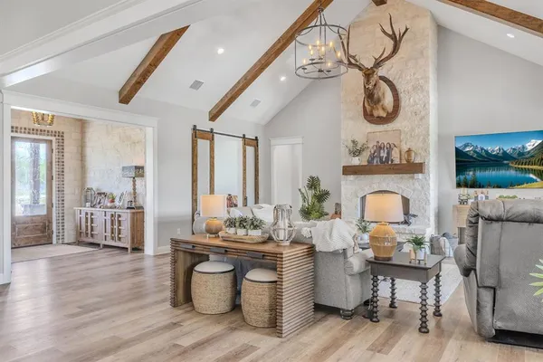 a living room with furniture a fireplace and a flat screen tv