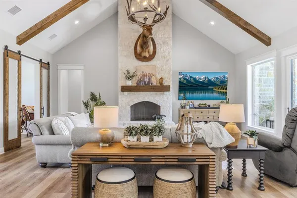 a living room with furniture a fireplace and white walls