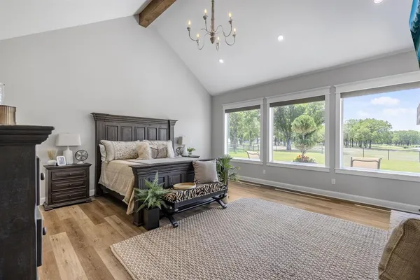 a bedroom with furniture and large window