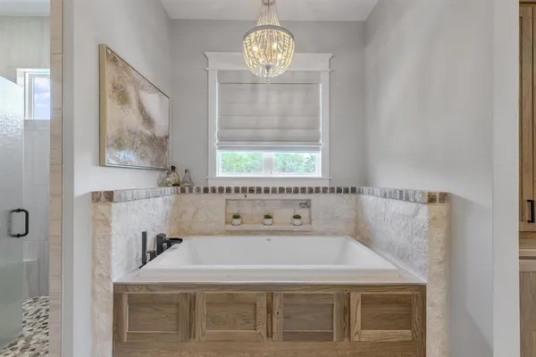 a bathroom with a granite countertop sink a large window and a mirror