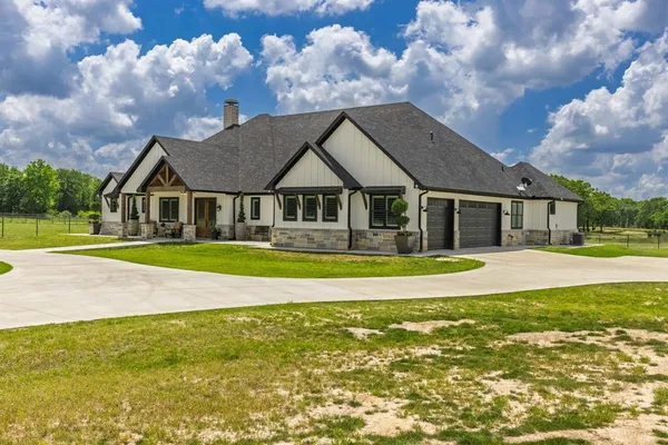 a front view of house with yard and swimming pool