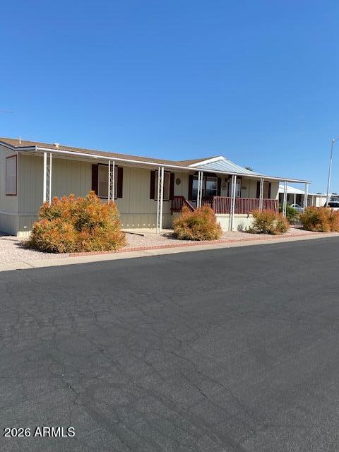 301 South Signal Butte Road, Unit 1124 Apache Junction, AZ 85120 - Photo 2 of 41 a front view of a house with yard