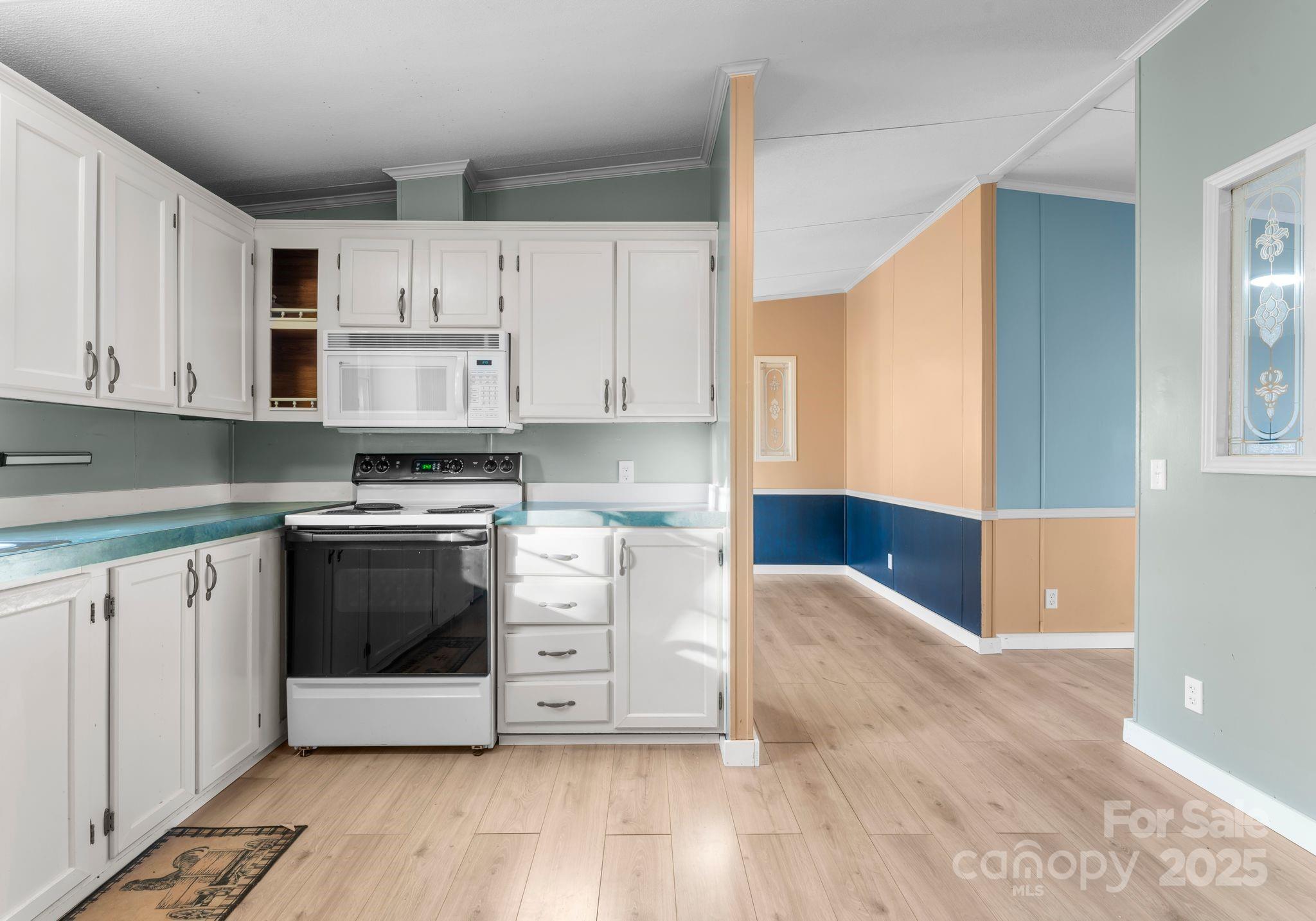 1812 Shearers Road Davidson, NC 28036 - Photo 12 of 40 a kitchen with stainless steel appliances white cabinets and a stove top oven