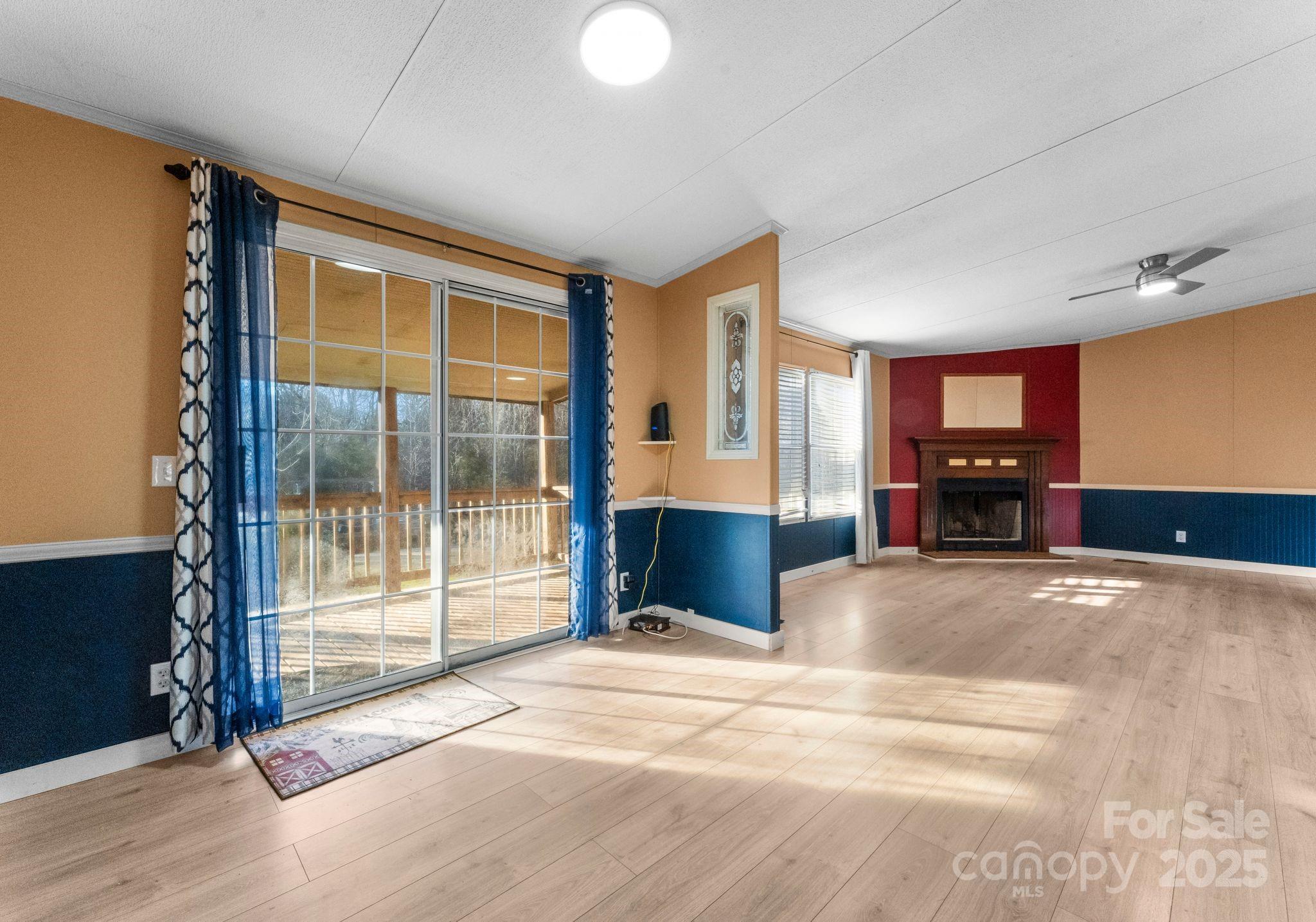 1812 Shearers Road Davidson, NC 28036 - Photo 16 of 40 a living room with a large window and a chandelier