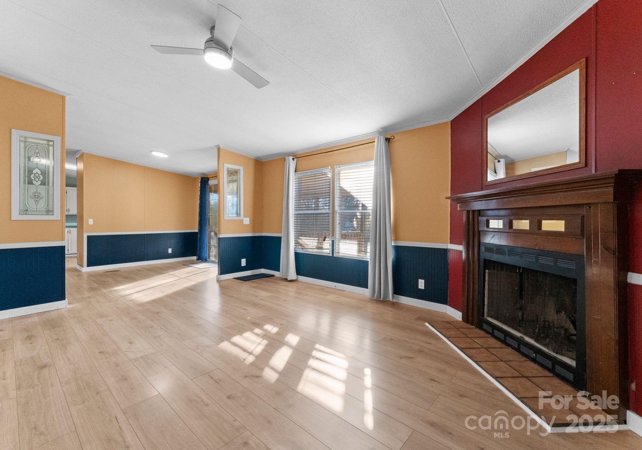 1812 Shearers Road Davidson, NC 28036 - Photo 18 of 40 a view of an empty room with a fireplace and window