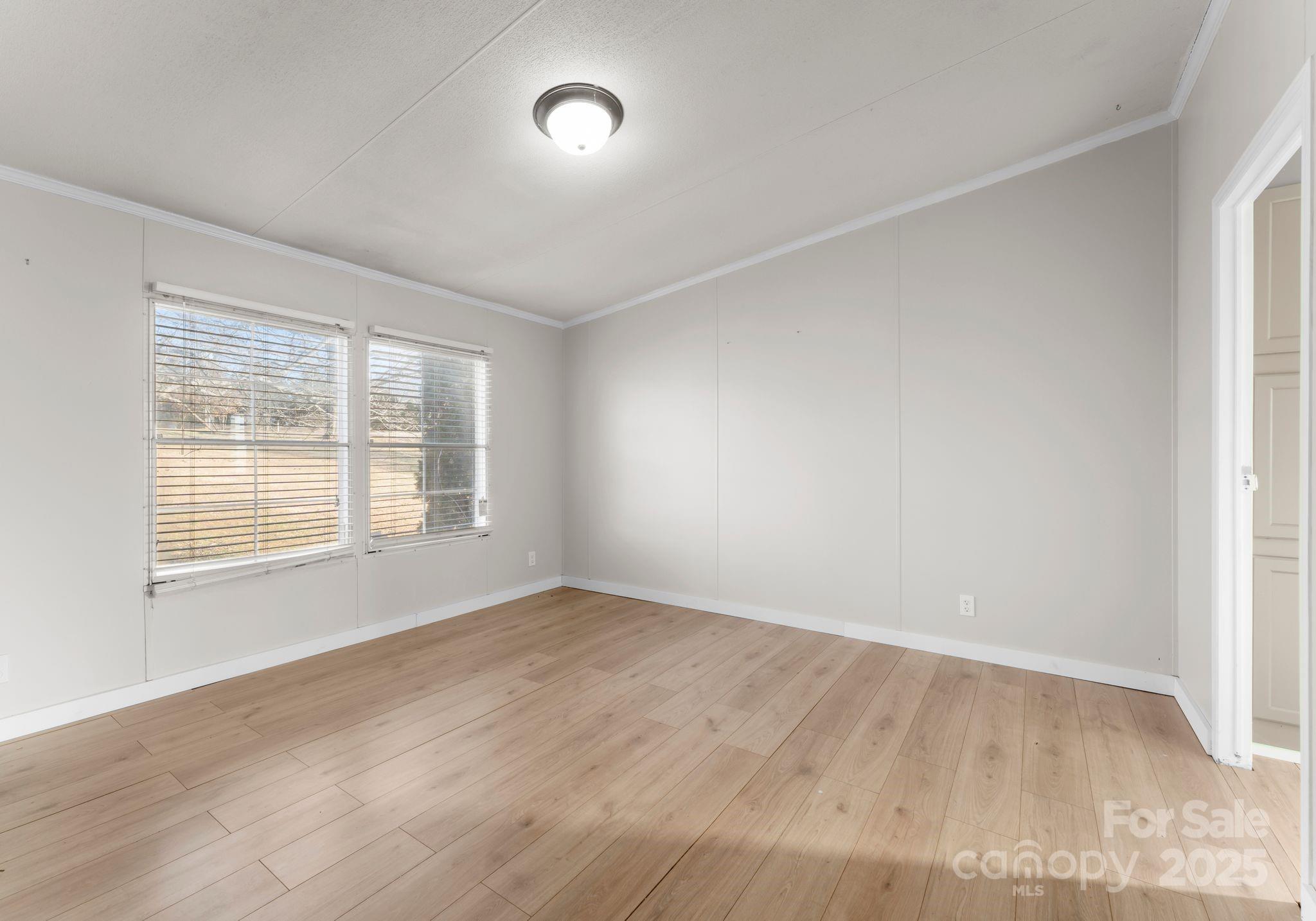 1812 Shearers Road Davidson, NC 28036 - Photo 21 of 40 an empty room with wooden floor and windows