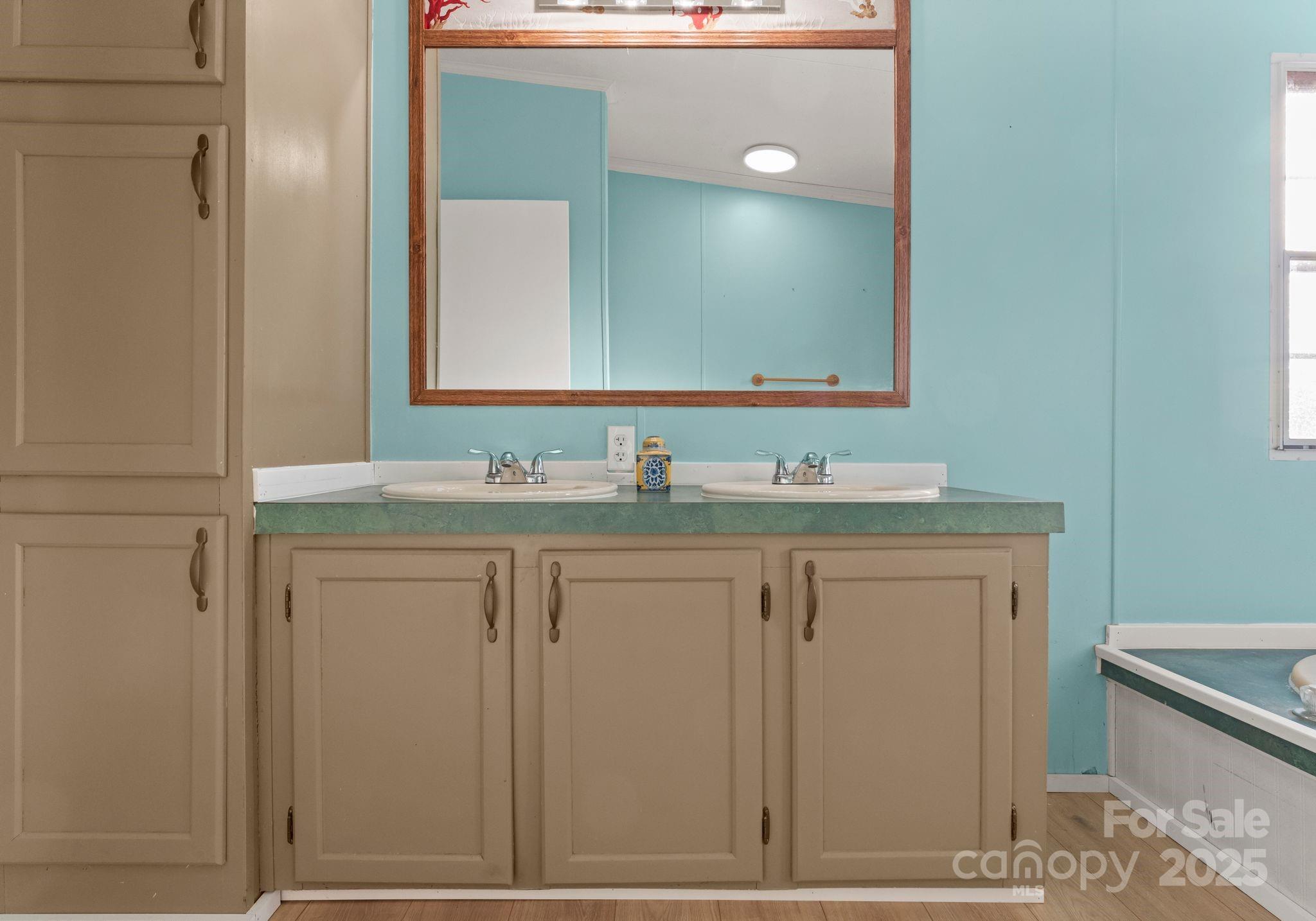 1812 Shearers Road Davidson, NC 28036 - Photo 22 of 40 a bathroom with a granite countertop sink and a mirror
