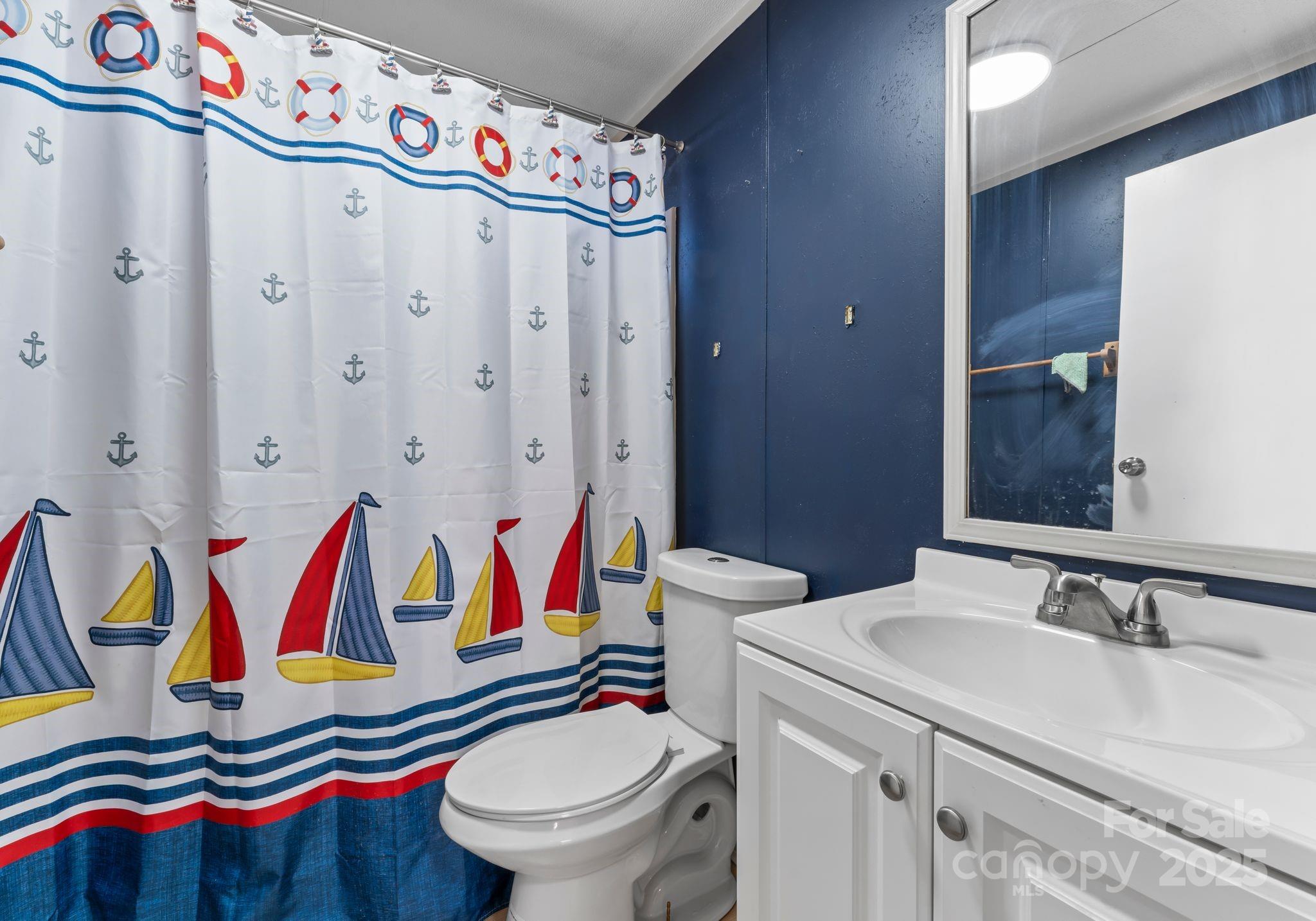 1812 Shearers Road Davidson, NC 28036 - Photo 28 of 40 a bathroom with a sink and a toilet