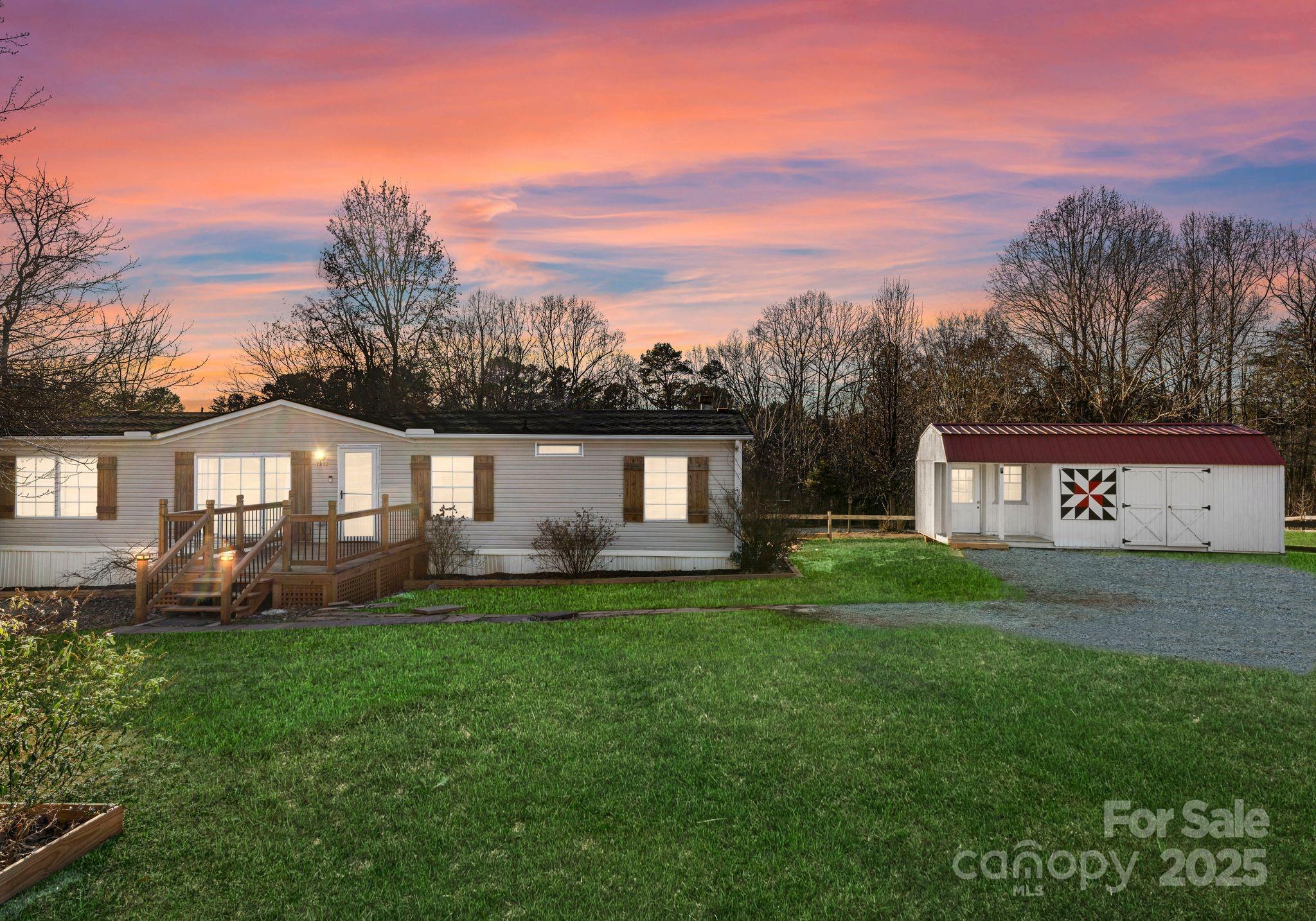 1812 Shearers Road Davidson, NC 28036 - Photo 3 of 40 a front view of a house with a yard and trees