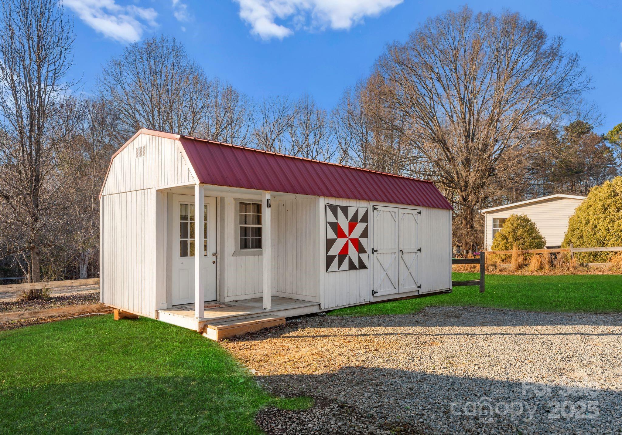 1812 Shearers Road Davidson, NC 28036 - Photo 36 of 40 a view of a barn with yard and wooden fence