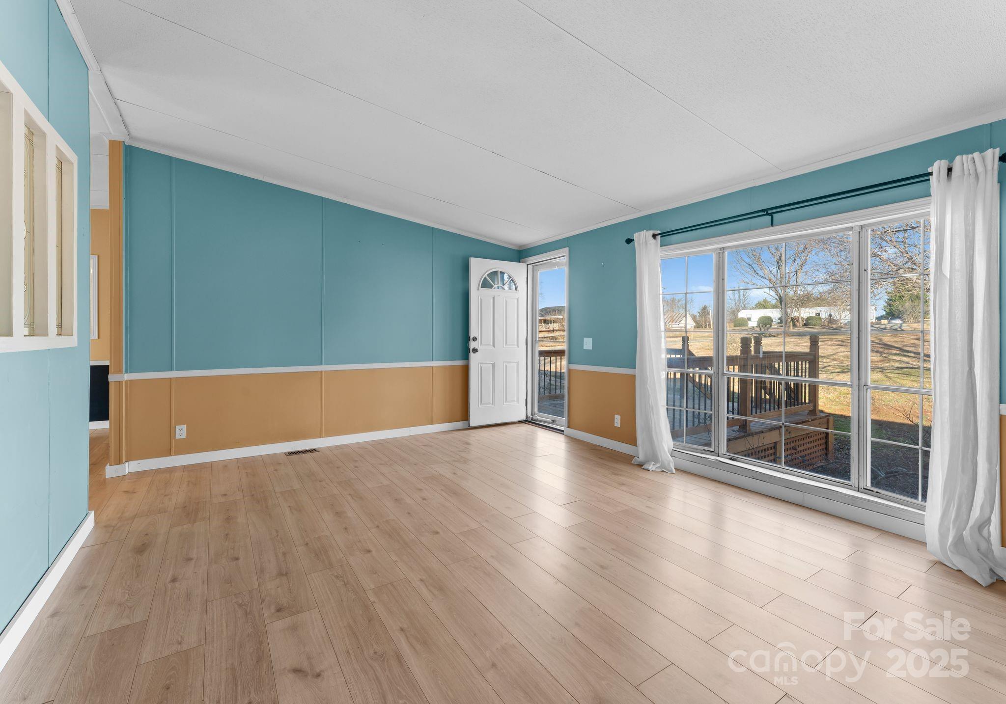 1812 Shearers Road Davidson, NC 28036 - Photo 7 of 40 a view of empty room with wooden floor and fireplace