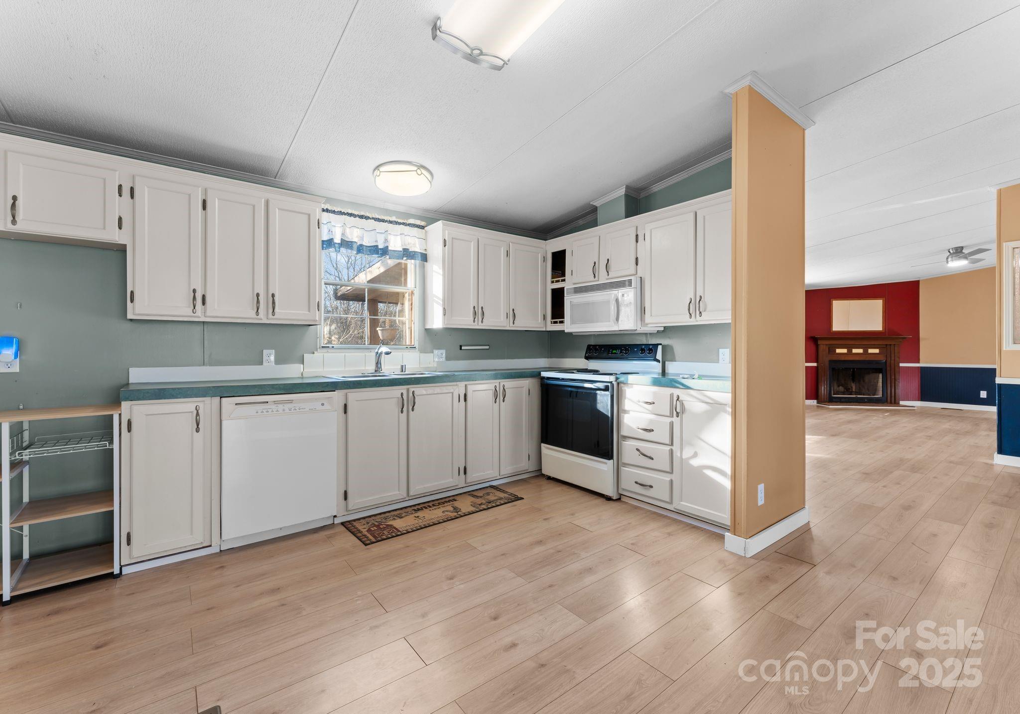 1812 Shearers Road Davidson, NC 28036 - Photo 10 of 40 a kitchen with stainless steel appliances granite countertop a stove top oven a sink and white cabinets