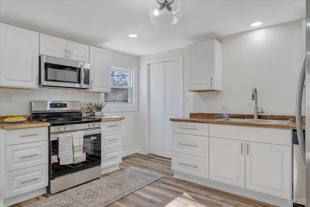 a kitchen with stainless steel appliances granite countertop a sink and a stove
