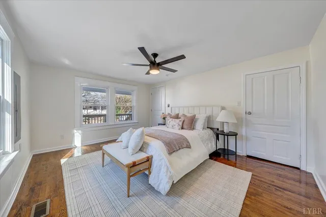 a spacious bedroom with a bed and a window