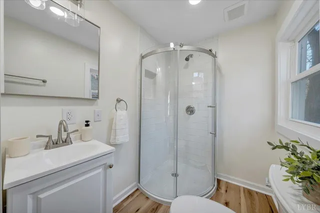 a view of empty room with wooden floor